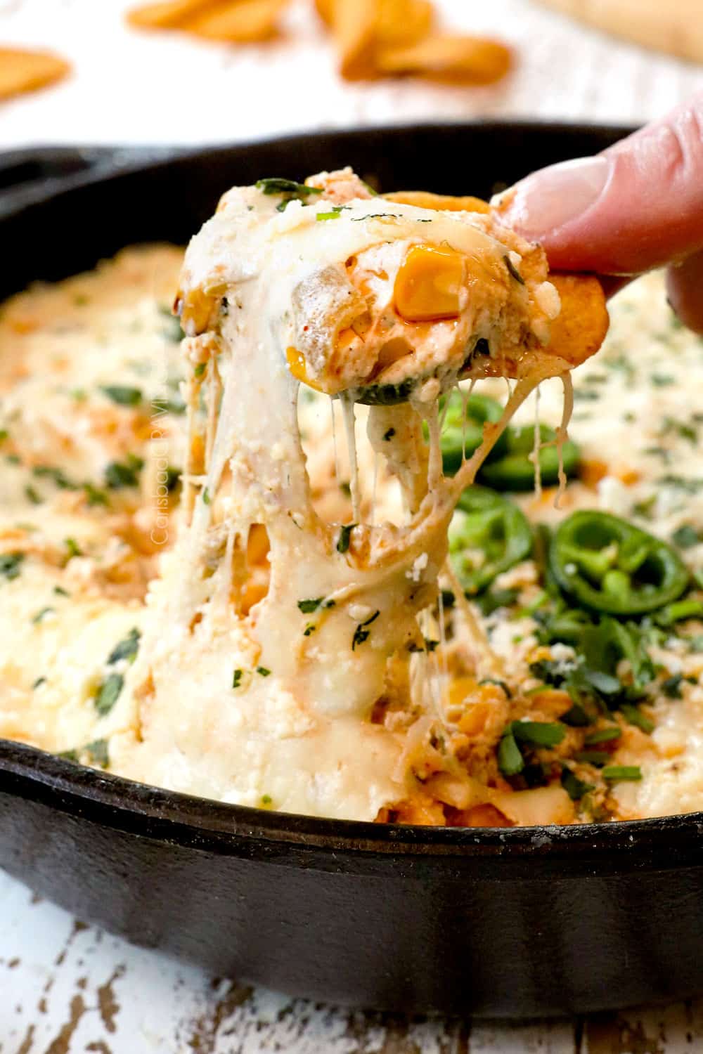a cheesy pull of Mexican Street Corn Dip showing how cheesy it is