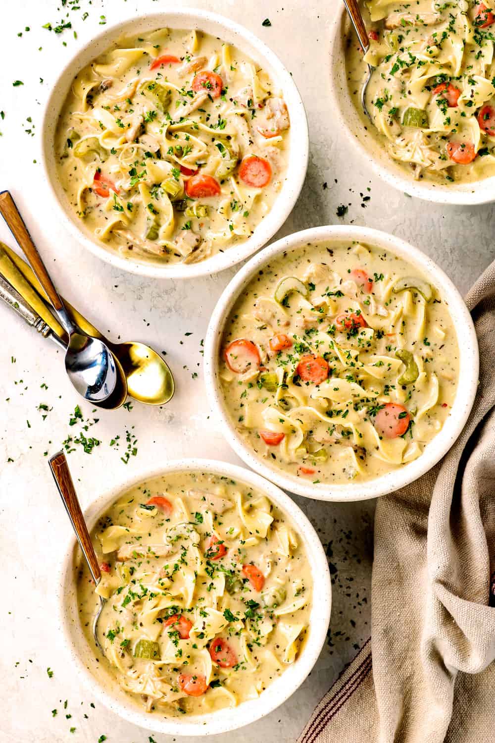 top view of four bowls of creamy chicken noodle soup recipe showing how rich and creamy it is