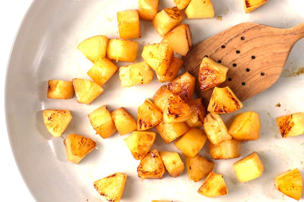 showing how to make healthy chicken teriyaki stir fry recipe by stir frying pineapple in a skillet