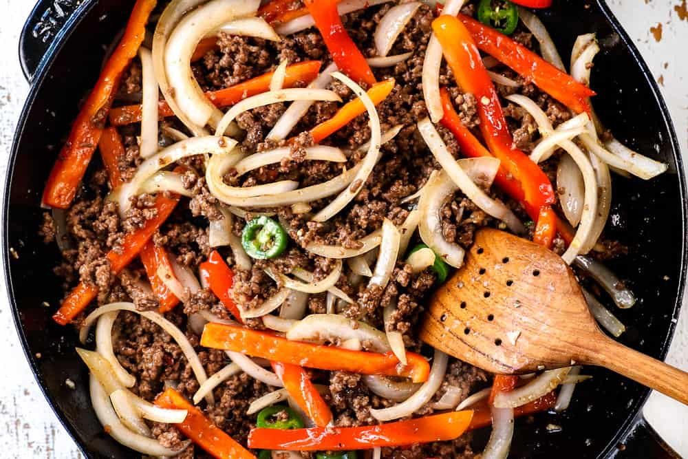 showing how to make Thai Basil Beef (pad krapow) by adding stir fry sauce to the ground beef and onions