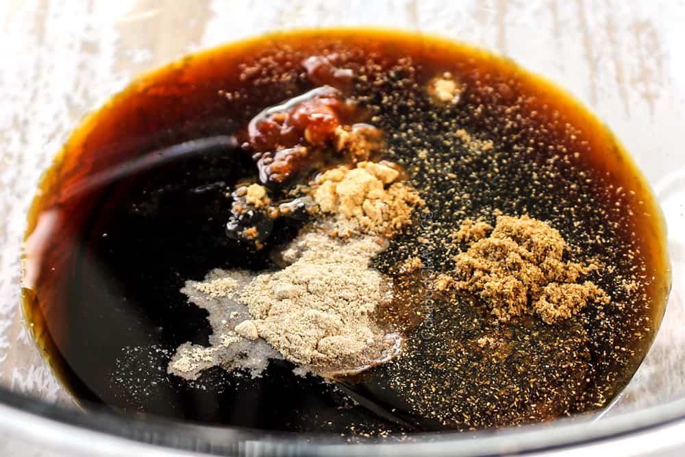 showing how to make Thai Basil Beef (pad krapow) by whisking soy sauce, oyster sauce, fish sauce, brown sugar together in a bowl