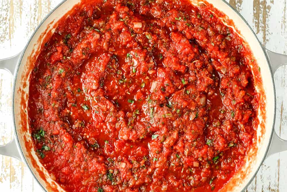 showing how to make tomato sauce by simmering until thickened