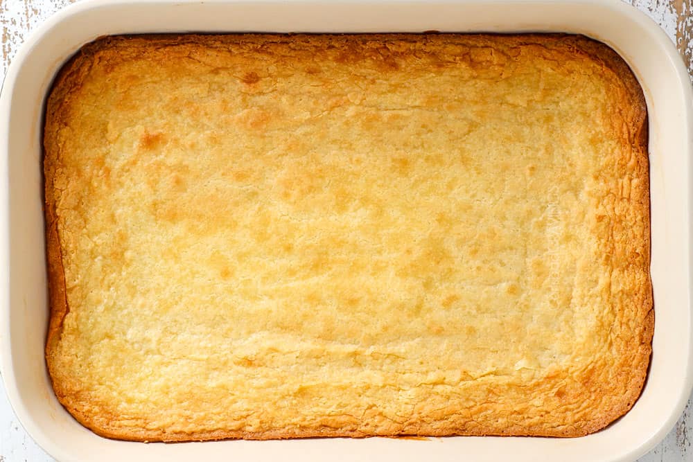 showing how to make Ooey Gooey Butter Cake recipe by baking until golden in a 9x13 pan