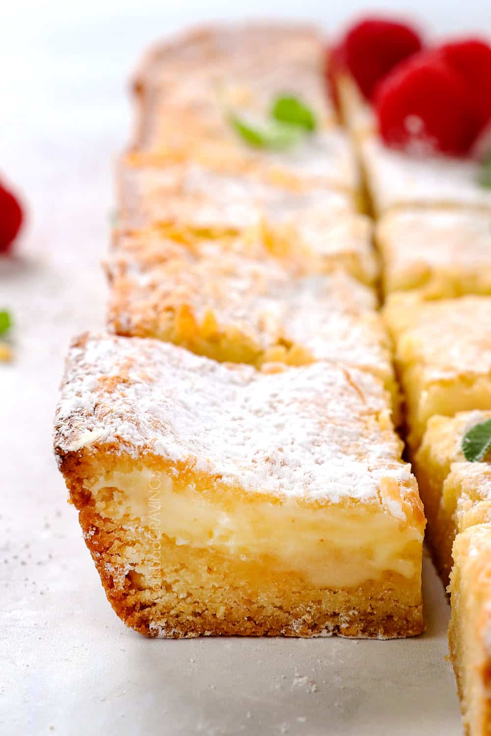 up close of a sliced Ooey Gooey Cake showing the bottom cake layer and gooey cream cheese layer