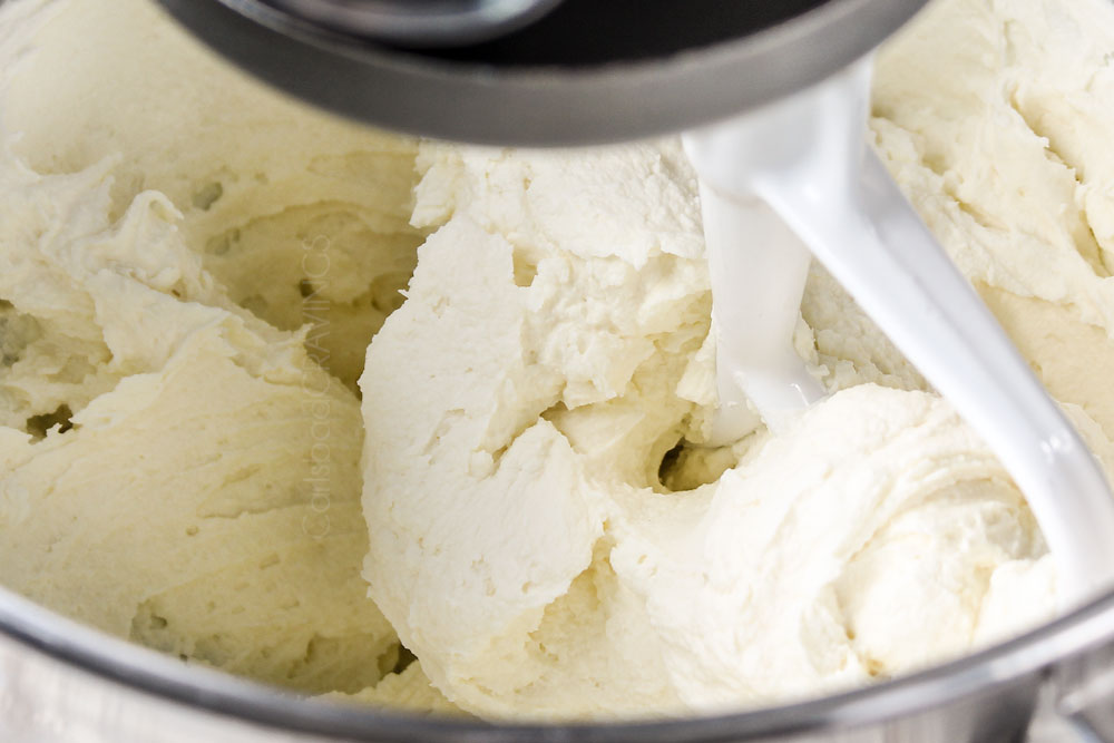 showing how to make Cannoli Dip recipe by beating ricotta and mascarpone together until fluffy