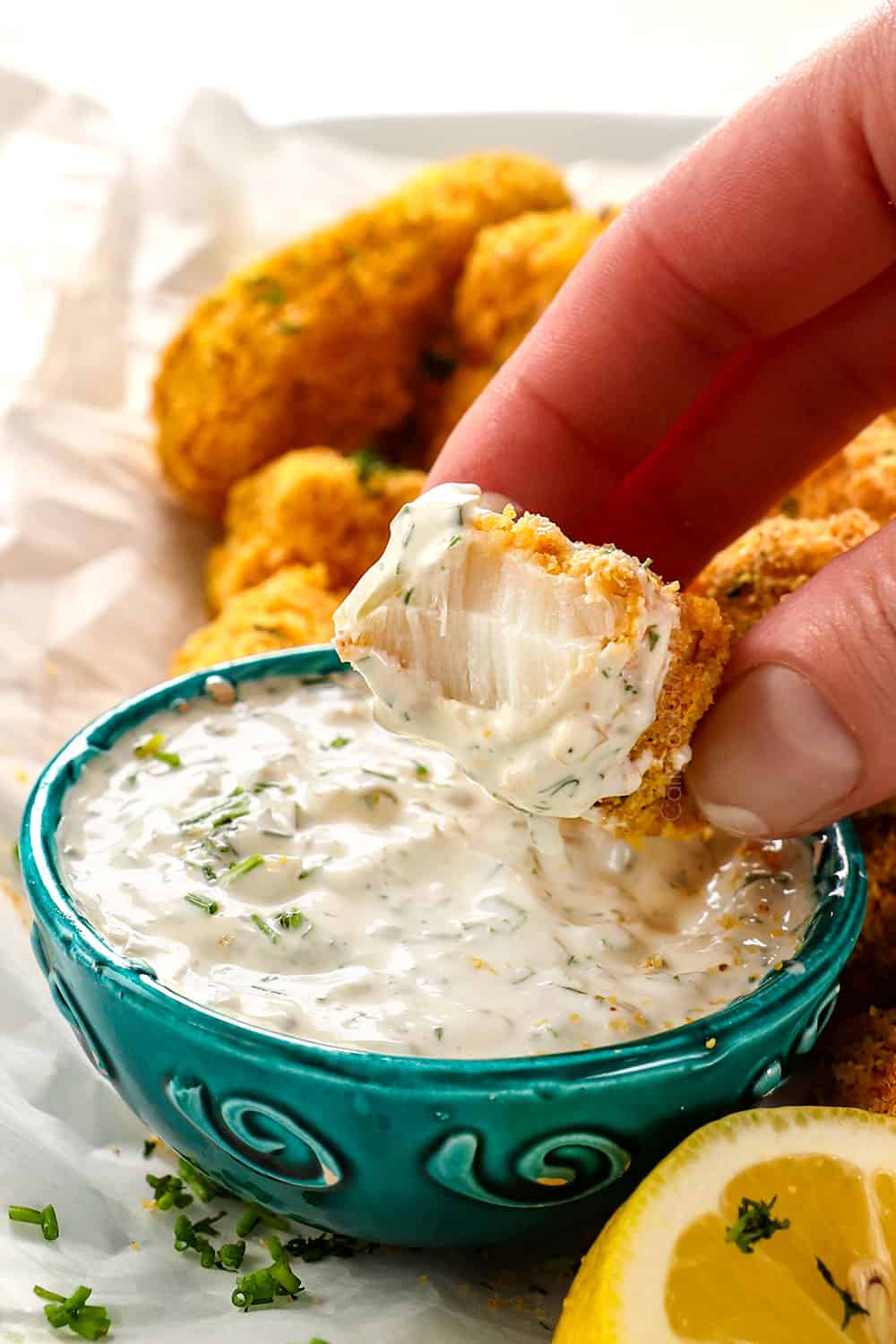 a bite take out of fishstick showing how crispy, juicy and flaky it is