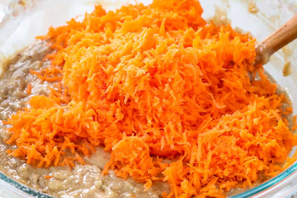 showing how to make carrot cake cupcakes by whisking carrots into the batter