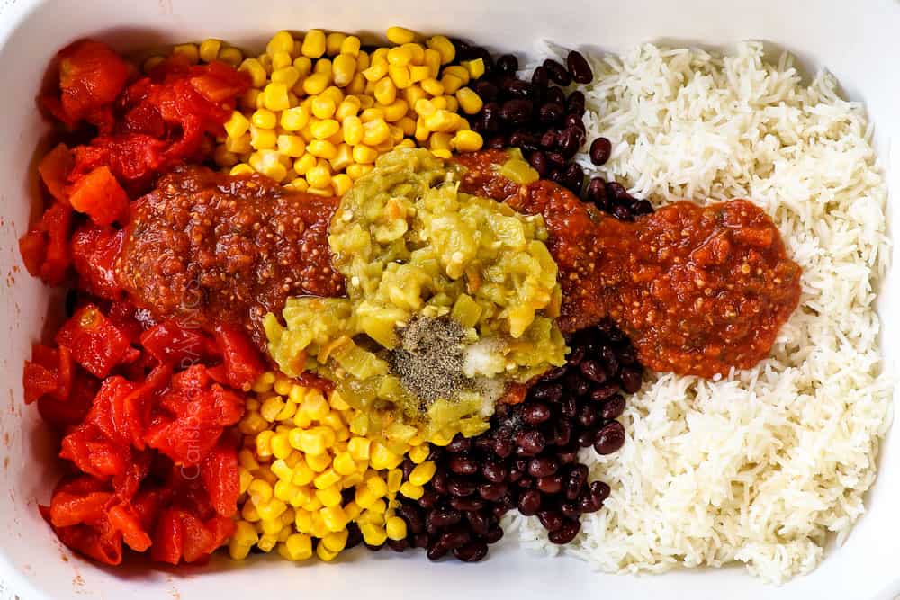 showing how to make Hasselback Chicken by adding rice, beans, corn and salsa to a 9x13 baking dish
