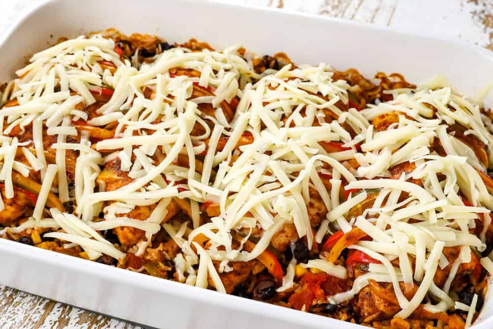 showing how to make Hasselback Chicken by adding cheese on top of baked Hasselback chicken