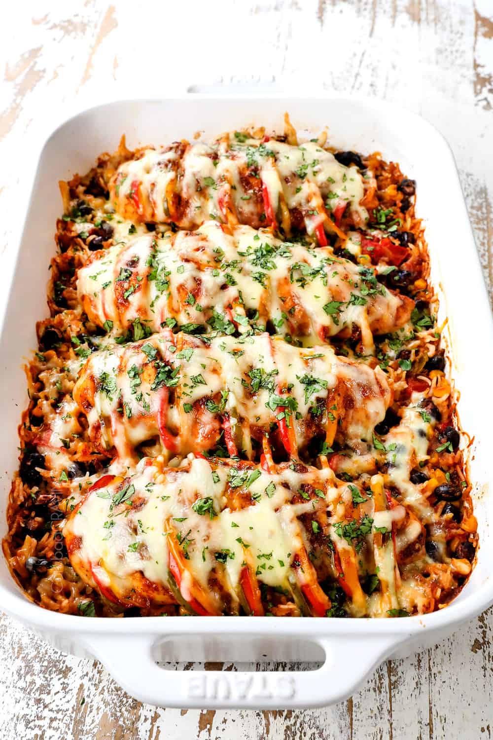 Hasselback chicken lined in a baking dish showing how to cook it