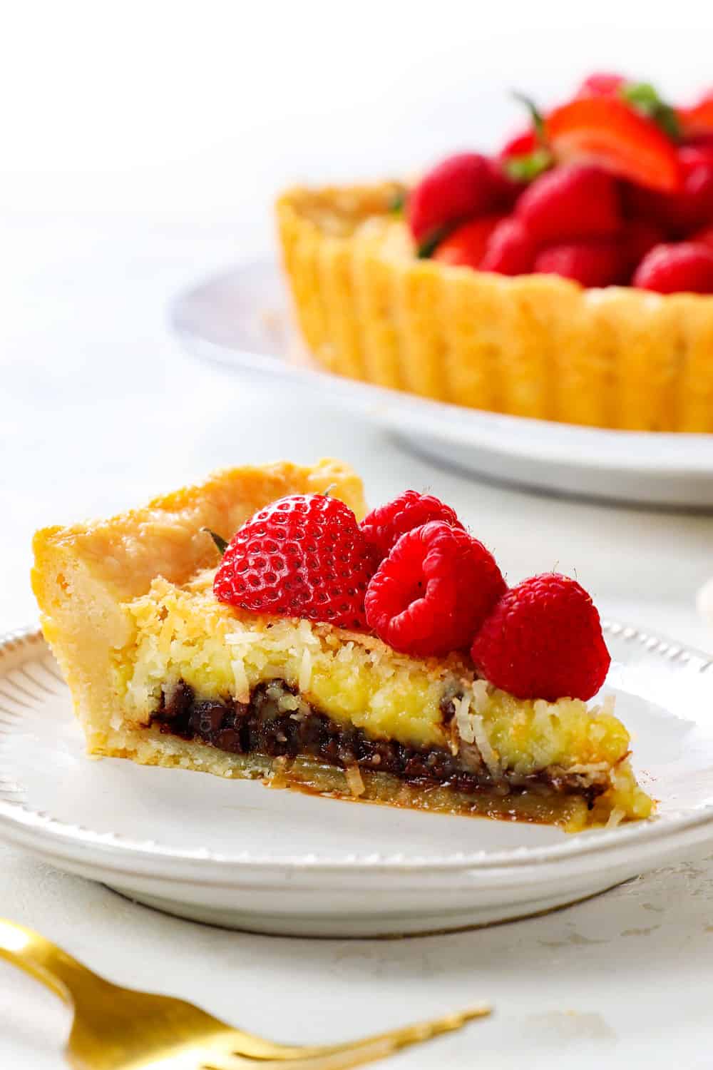 up close of a slice of coconut custard pie recipe showing the creamy custard layer and the coconut top crust