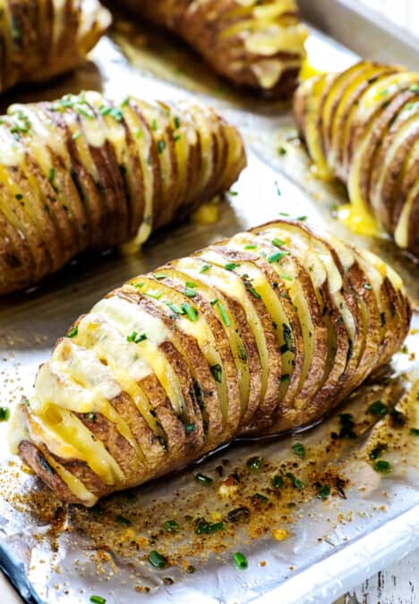 showing how to make Hasselback potato recipe by baking potatoes by garnishing with chives