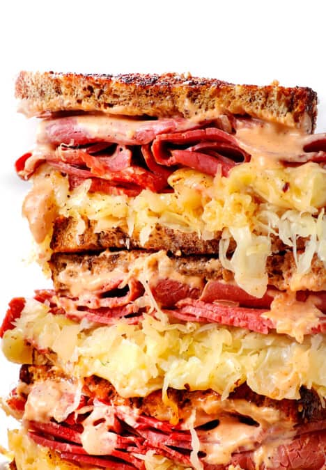 up close of Reuben sandwich sliced and stacked showing how cheesy it is