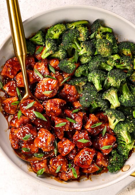 top view of sesame chicken recipe in a skillet with stir fried broccoli