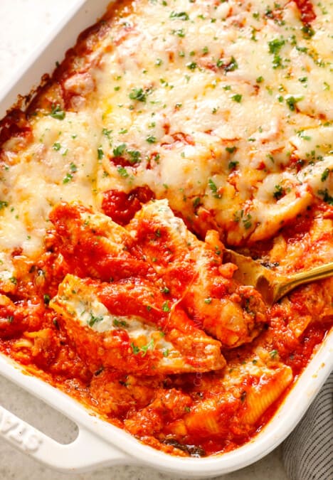 scooping up stuffed shells with meat showing how meaty and cheesy it is