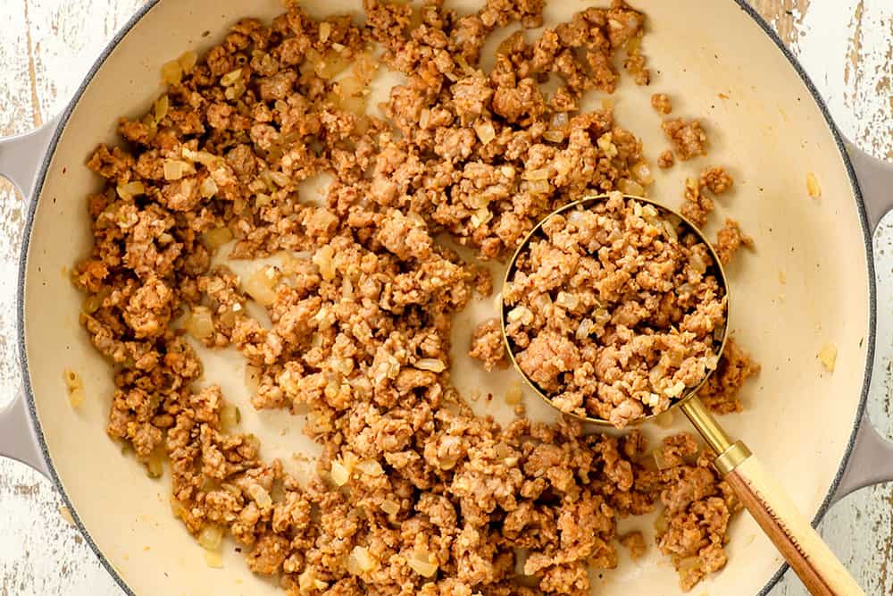 showing how to make stuffed shells recipe by cooking meat in a skillet