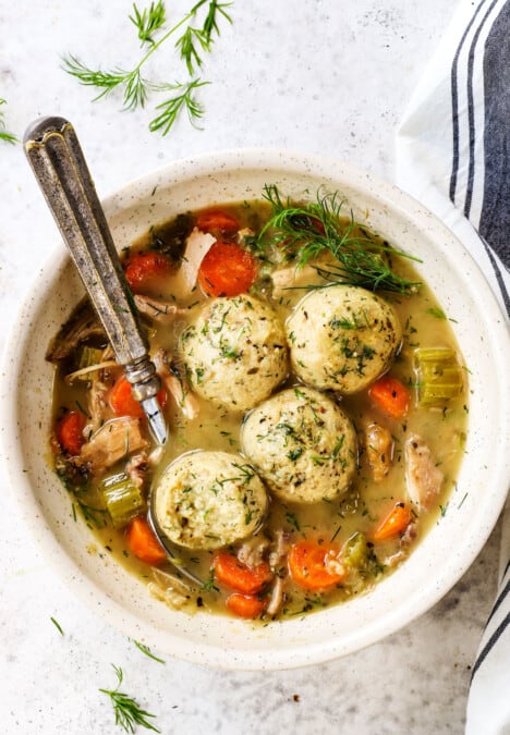 a bowl of matzo ball soup with matzo balls and chicken