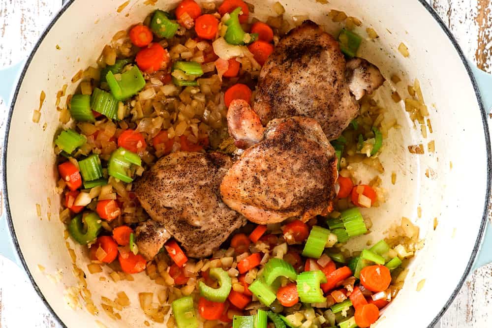 showing how to make matzo ball soup by recipe by adding seasonings and chicken back to the pot