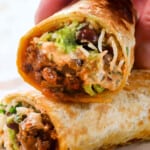 showing how to serve chipotle crema sauce by drizzling on a burrito