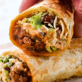 showing how to serve chipotle crema sauce by drizzling on a burrito