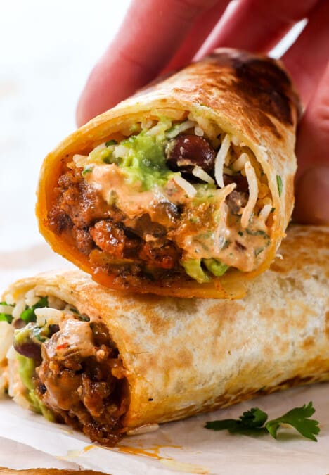 showing how to serve chipotle crema sauce by drizzling on a burrito