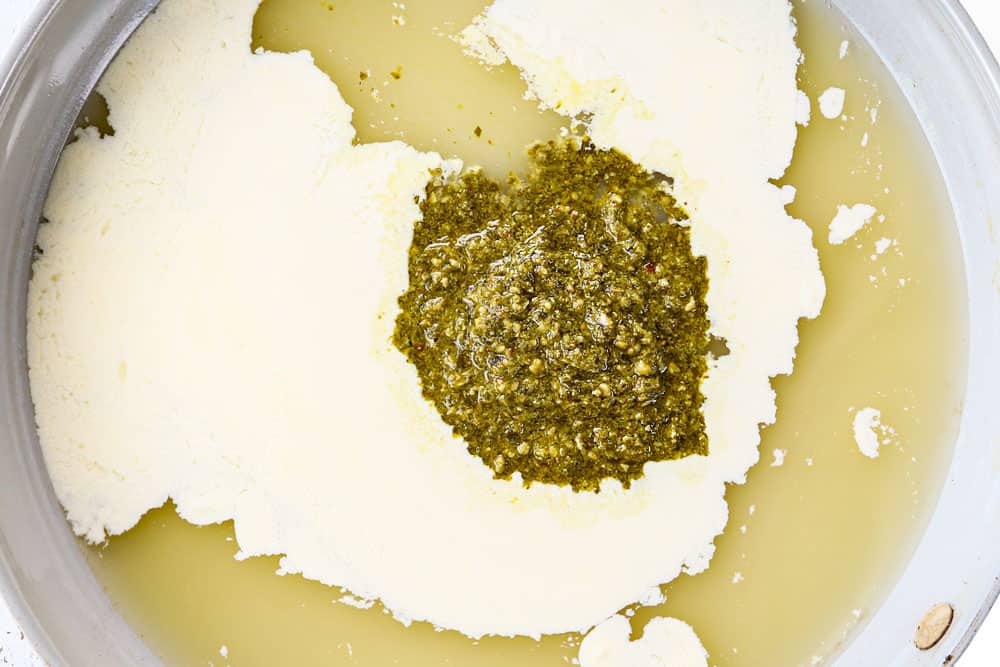 showing how to make tilapia recipe by making a sauce with heavy cream, pesto, chicken broth and cornstarch