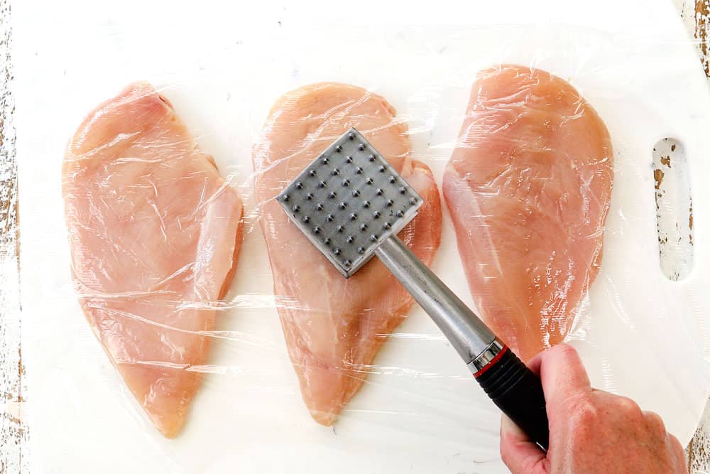 showing how to make chicken chimichurri by pounding the chicken to an even thickness using a meat mallet