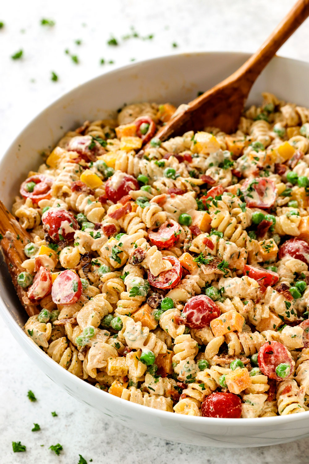 a bowl of pasta bacon ranch salad with peas, bacon and ranch with sour cream