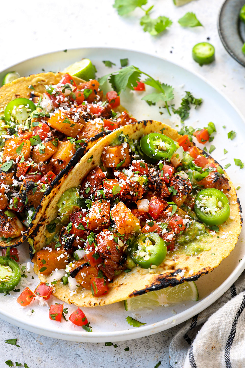 chicken al pastor served in tacos with guacamole, pineapple, Cotija and pico de gallo