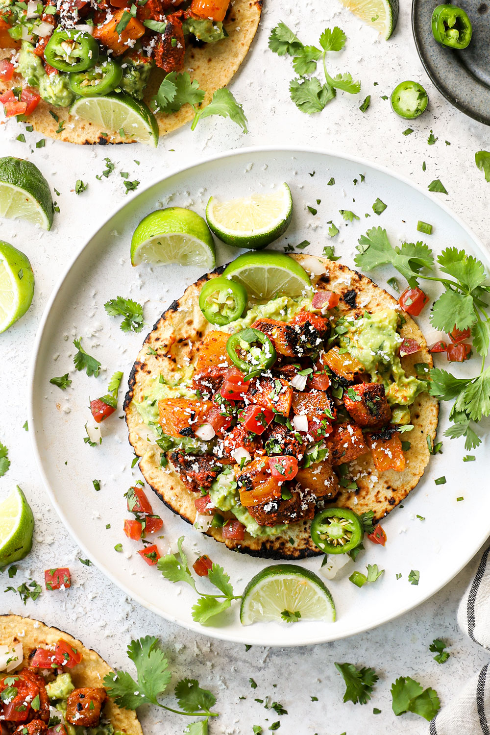 top view of chicken al pastor on a corn tortilla with pineapple and guacamole to make tacos