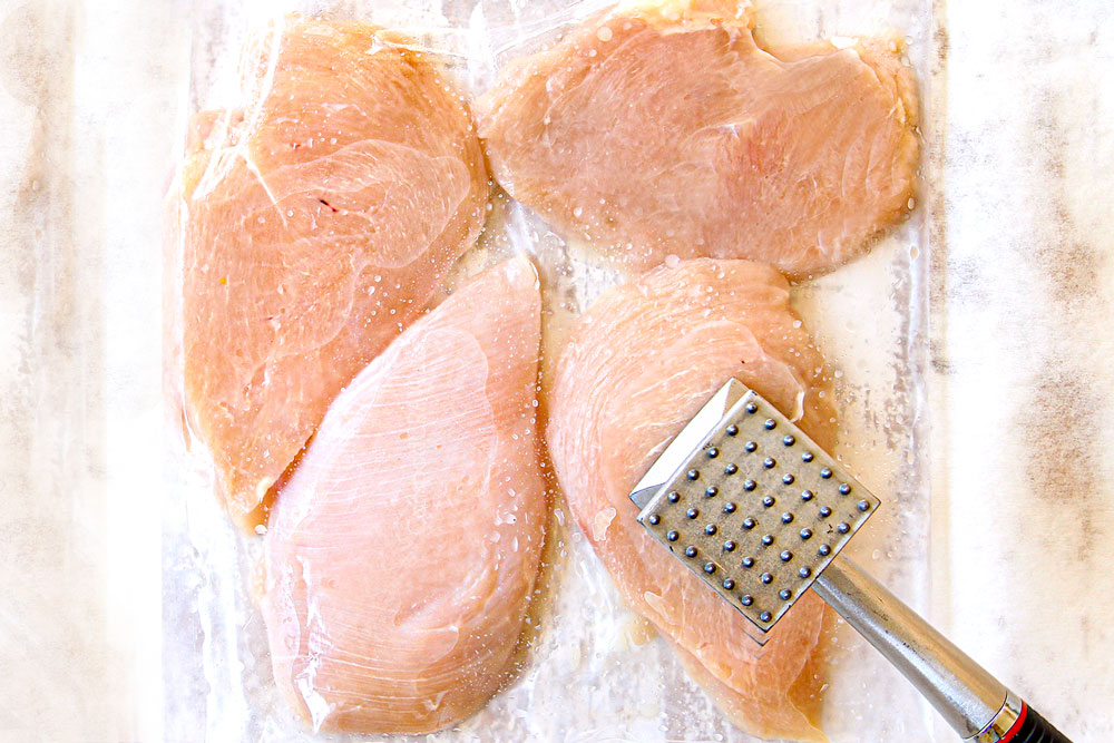 showing how to make Caesar Pasta salad by pounding the chicken to an even thickness with a meat mallet