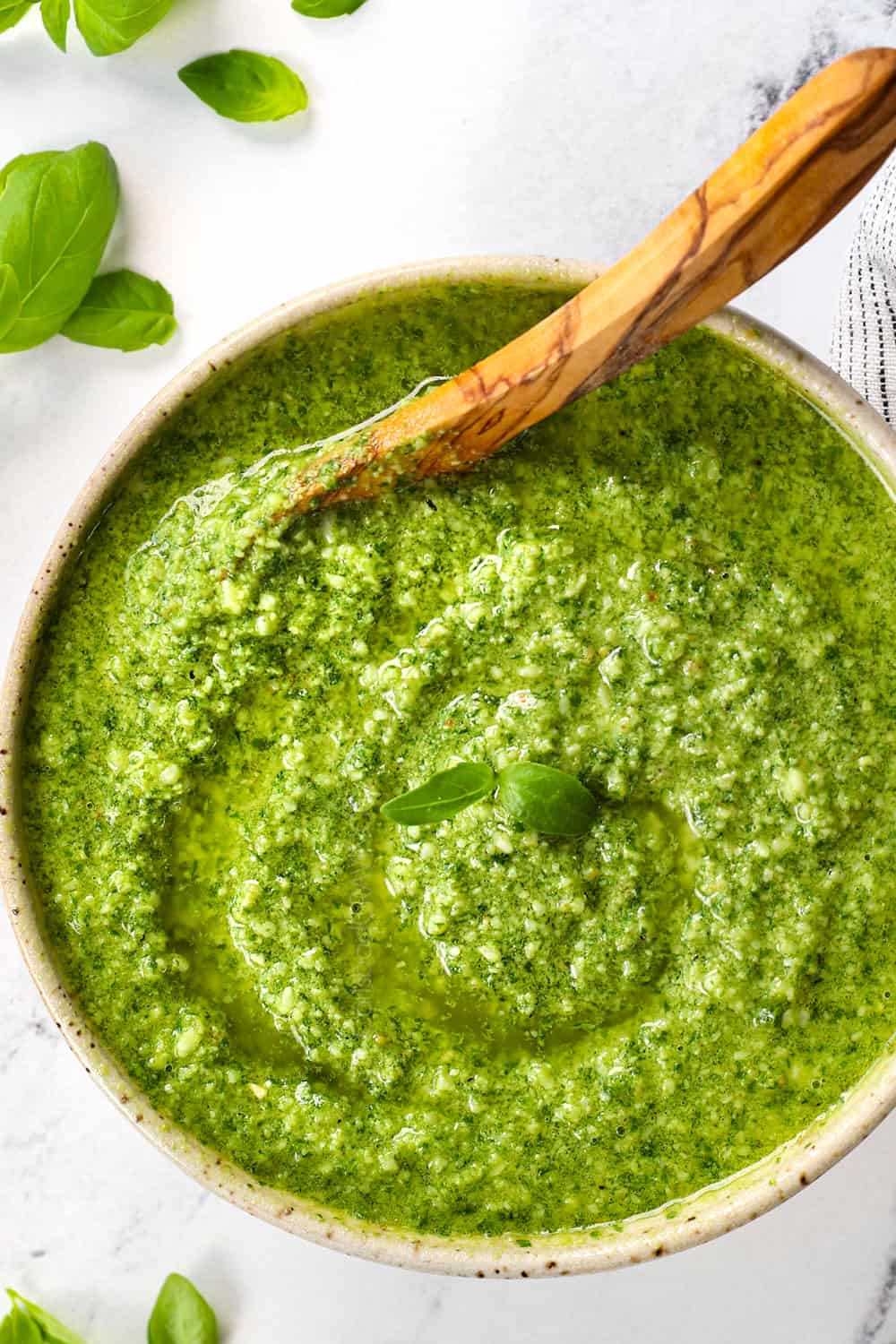 top view of homemade basil pesto recipe in a bowl showing the thick consistency