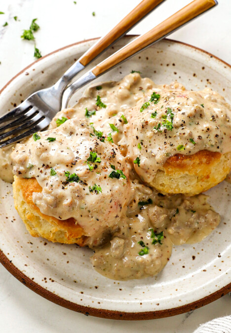 a plate of sausage gravy and biscuits showing how creamy the gravy is