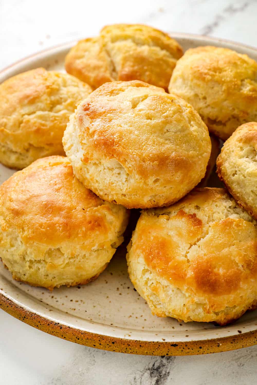 showing how to make homemade biscuits and gravy recipe by baking the homemade biscuits until golden