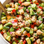 a bowl ceviche de camaron (shrimp ceviche) with tomatoes, cucumbers, avocados, red onions, jalapenos and cilantro