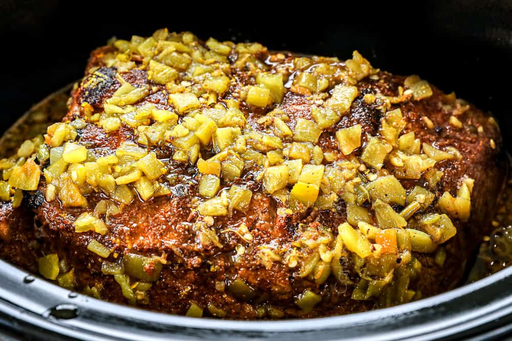 showing how to make BBQ pulled pork by cooking pork in a slow cooker until tender