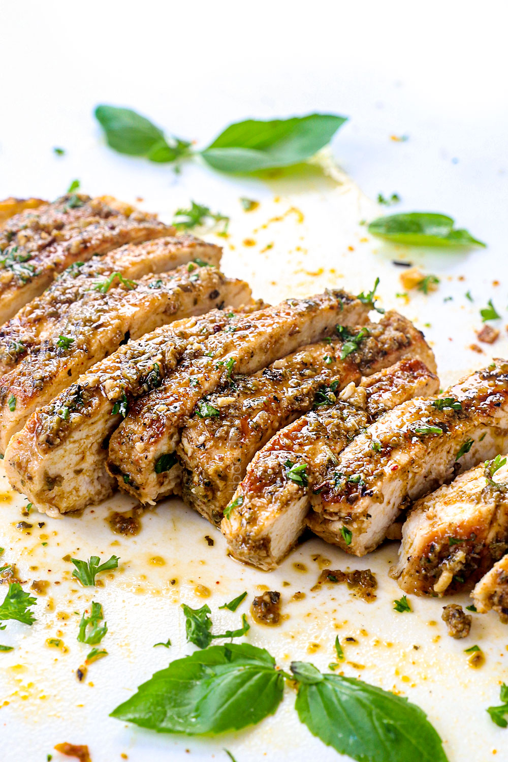 up close of sliced Italian Chicken on a cutting board showing how juicy it is