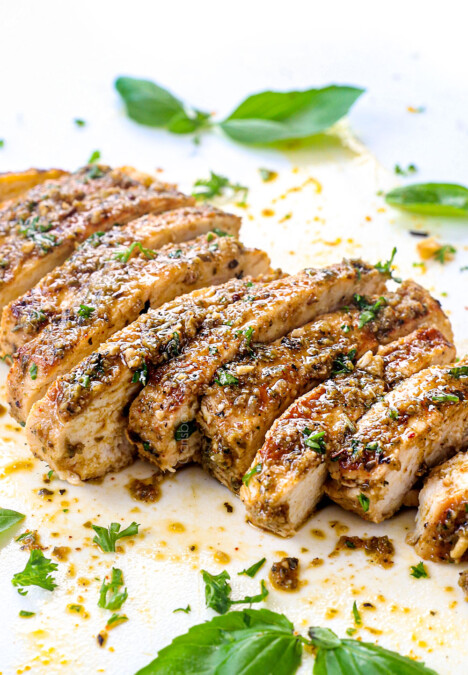 up close of sliced Italian Chicken on a cutting board showing how juicy it is