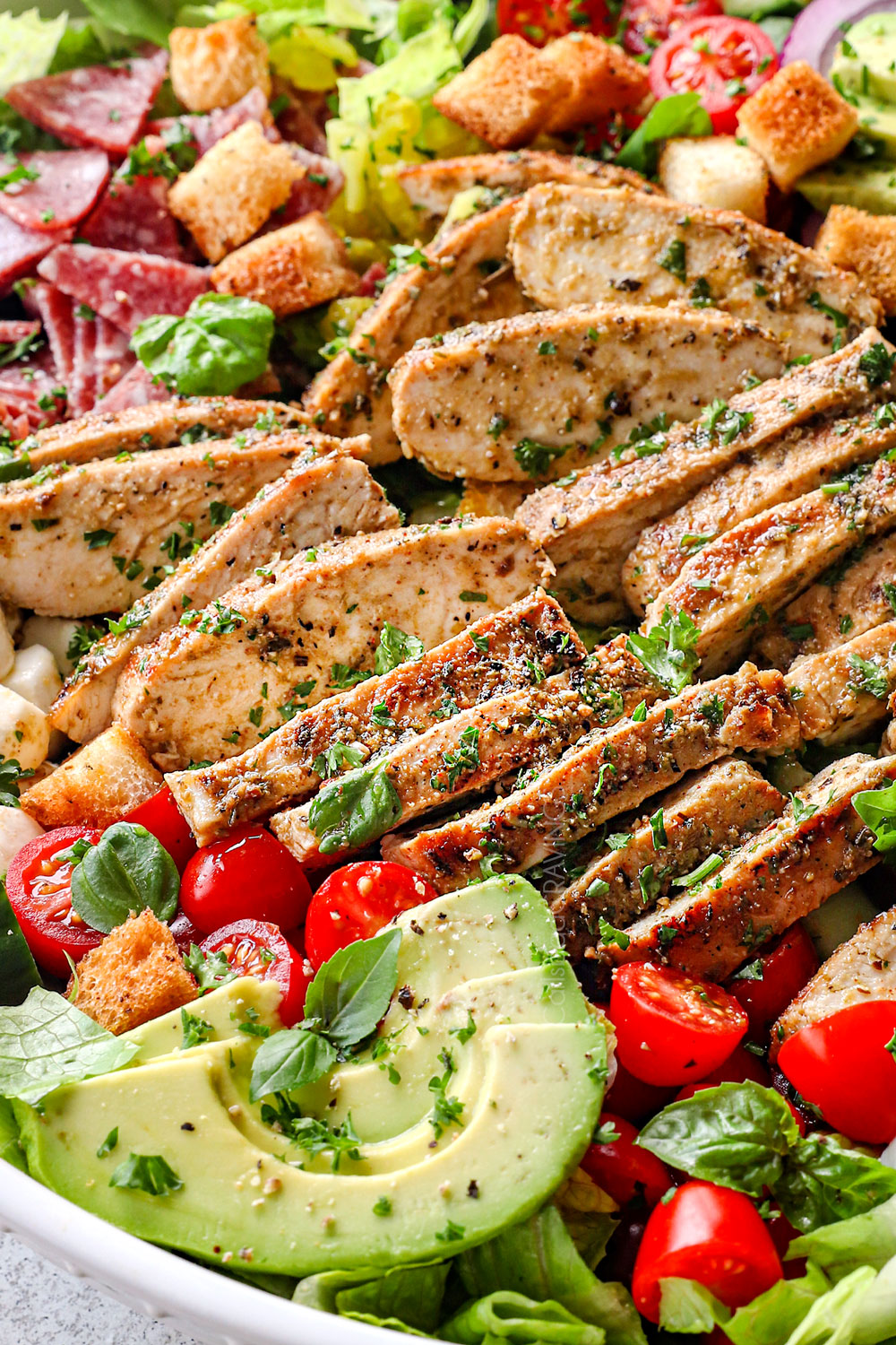 showing how to serve Italian Chicken Marinade recipe by adding to an Italian Salad