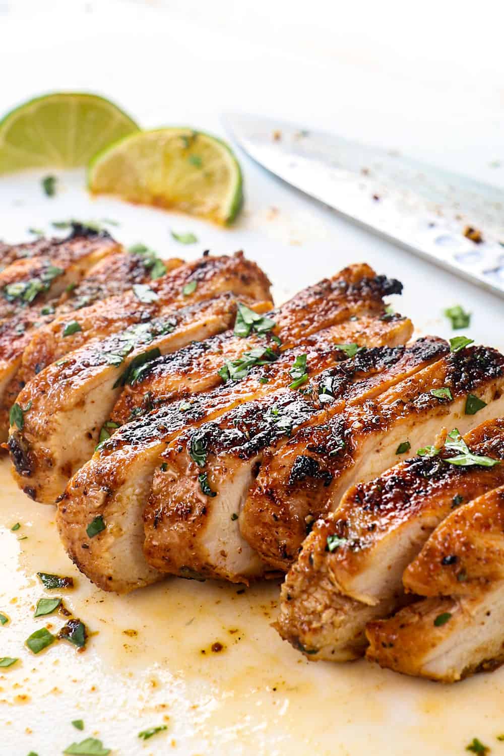 showing how to use Jamaican jerk seasoning by spice rubbing chicken