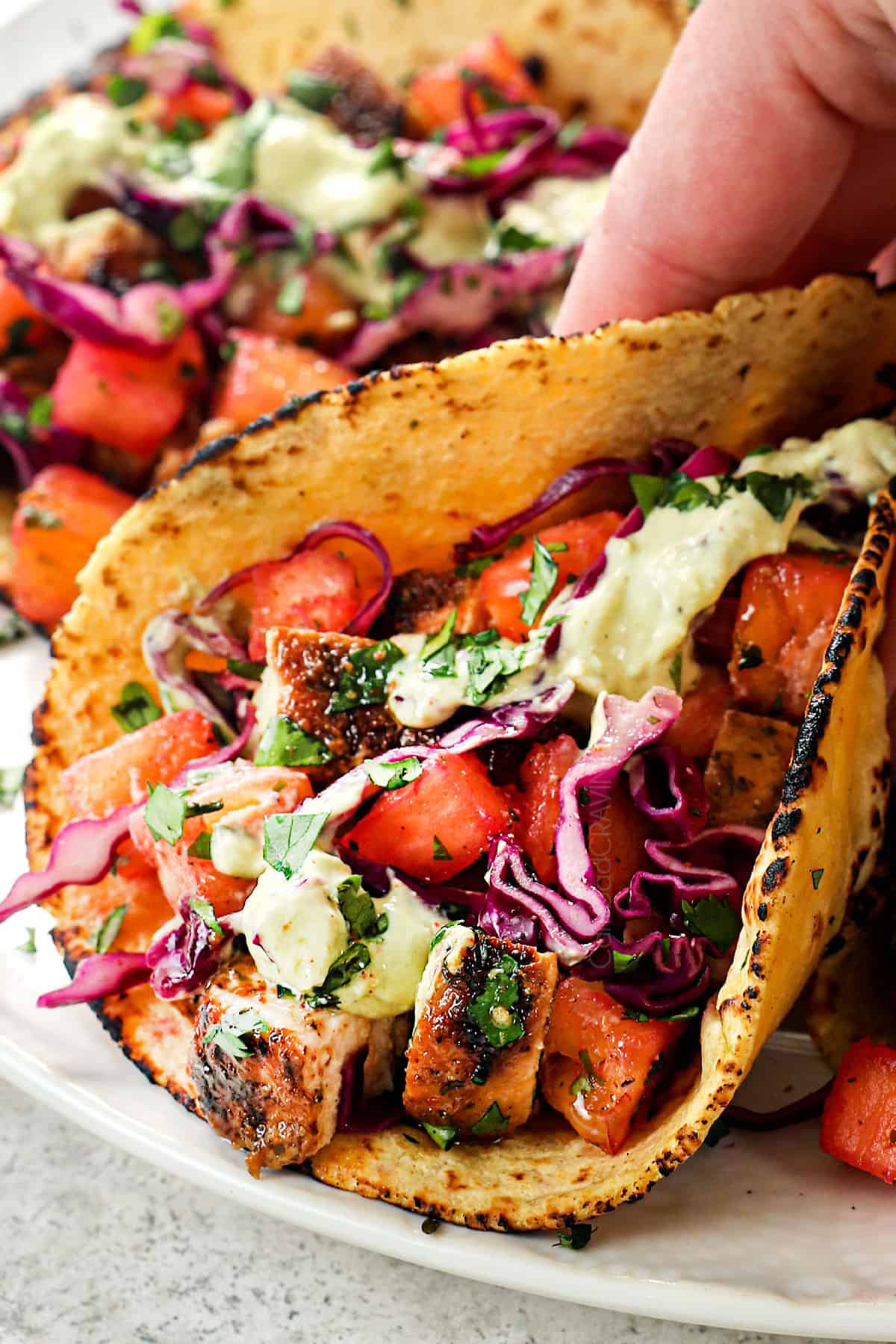 picking up jerk chicken tacos with pineapple slaw