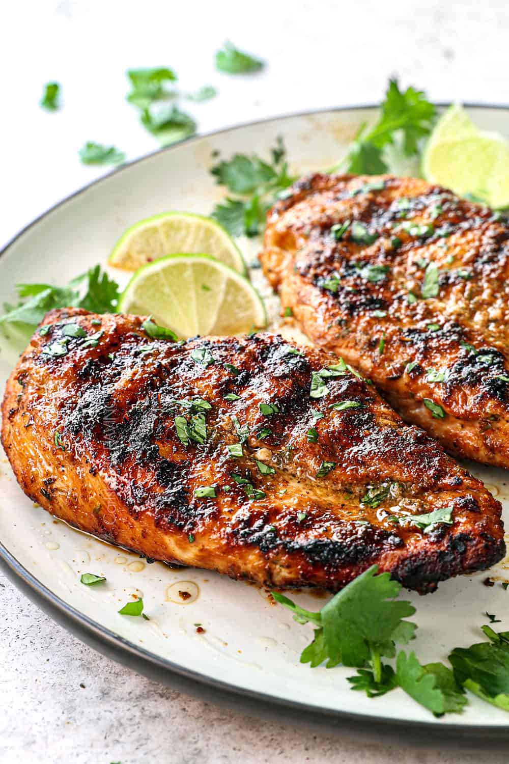 showing how to make jerk chicken tacos by cooking chicken until charred