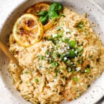 top view of lemon orzo with chicken garnished by basil