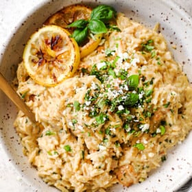 top view of lemon orzo with chicken garnished by basil