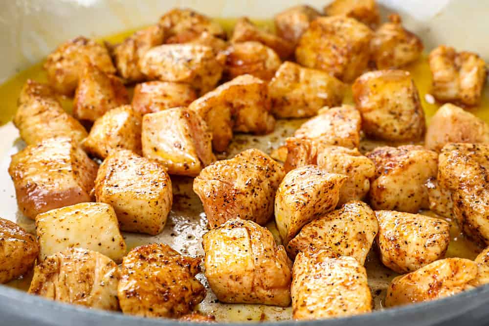showing how to make lemon chicken orzo by browning chicken in a skillet