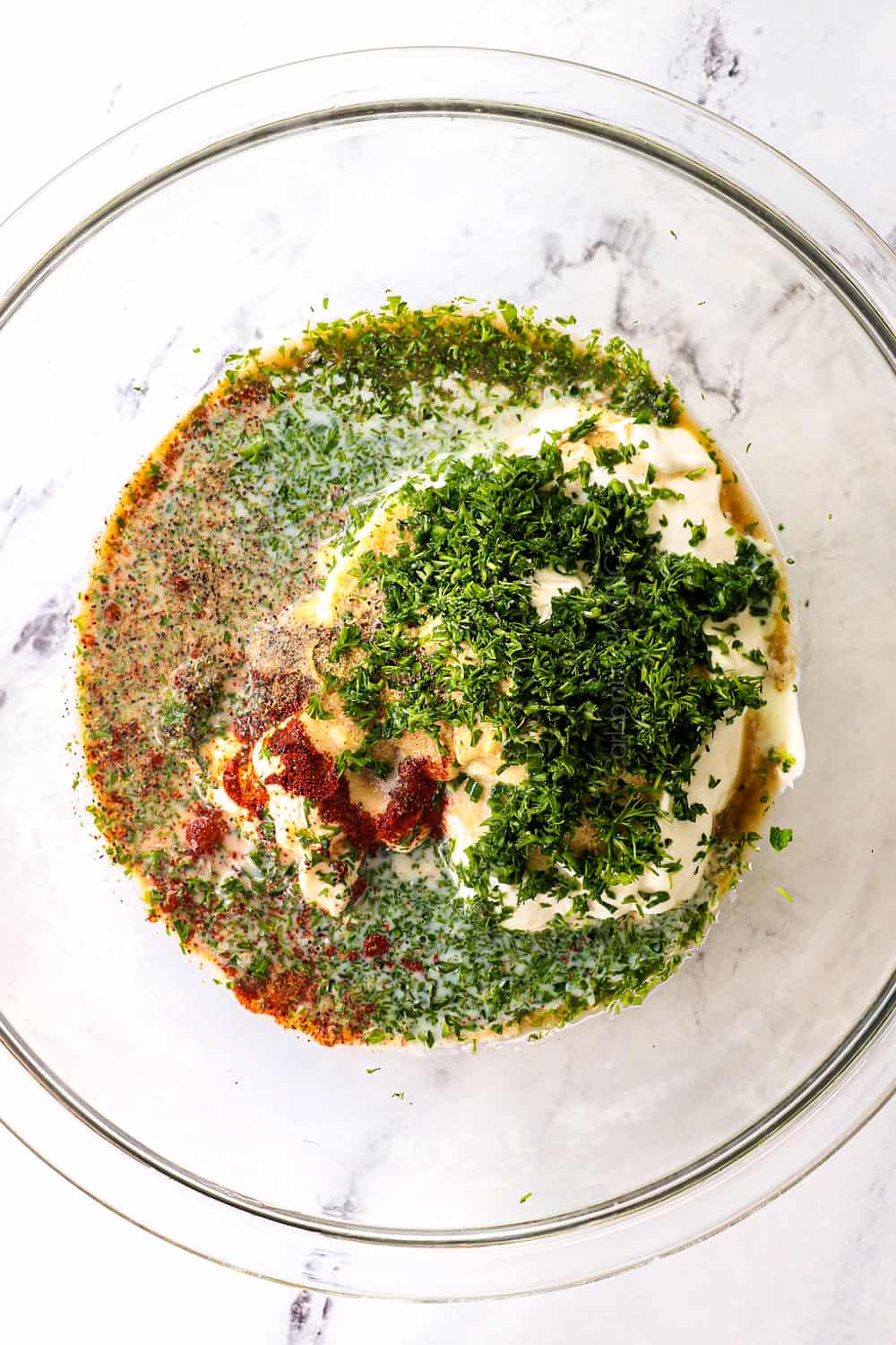 showing how to make garden salad by whisking all of the salad dressing ingredients together in a bowl