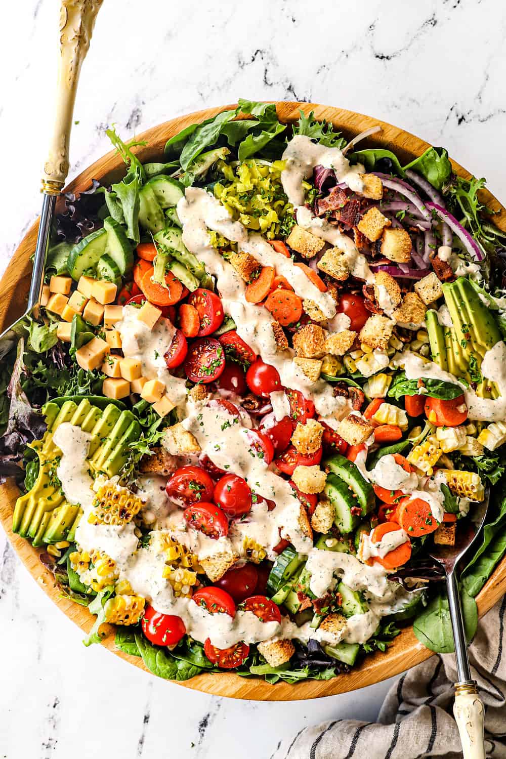 top view showing how to make garden salad recipe by topping with ranch dressing