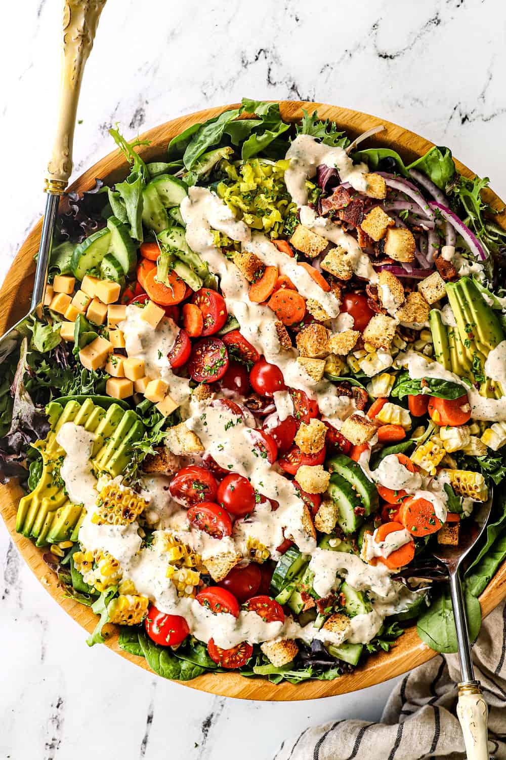 showing how to serve ranch dressing by drizzling over a salad