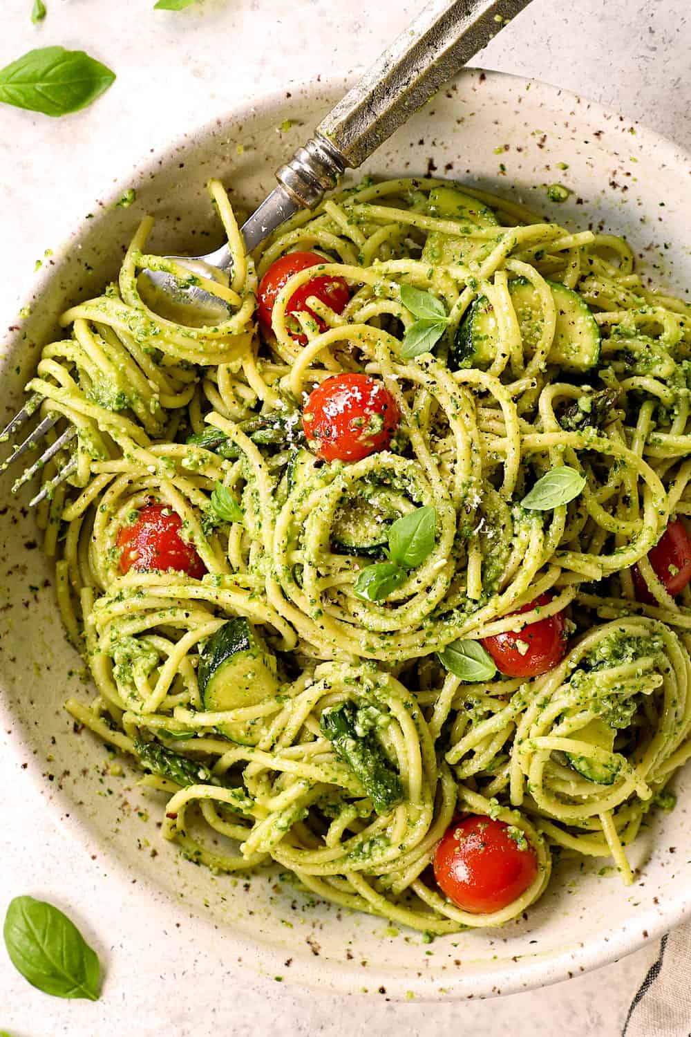 top view of pesto pasta in a bowl with roasted vegetables
