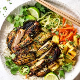 top view Thai chicken sliced and served over rice with pickled vegetables